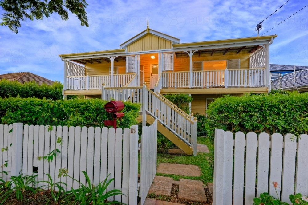 Queenslander home in Brisbane photographed at dusk - Australian Stock Image