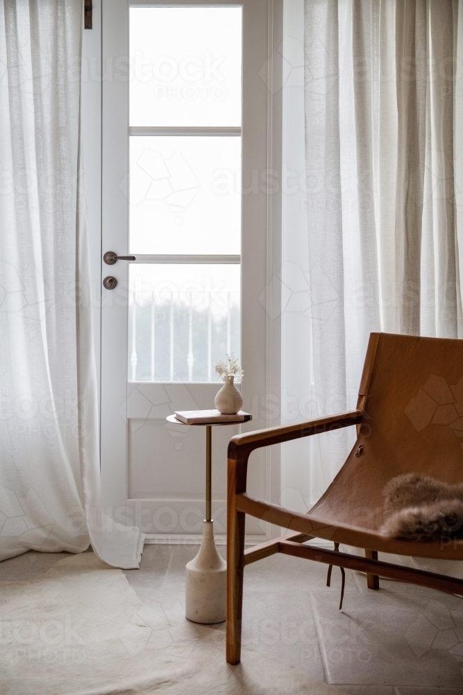 Quiet corner for self reflection with a sling chair and curtains in the background - Australian Stock Image