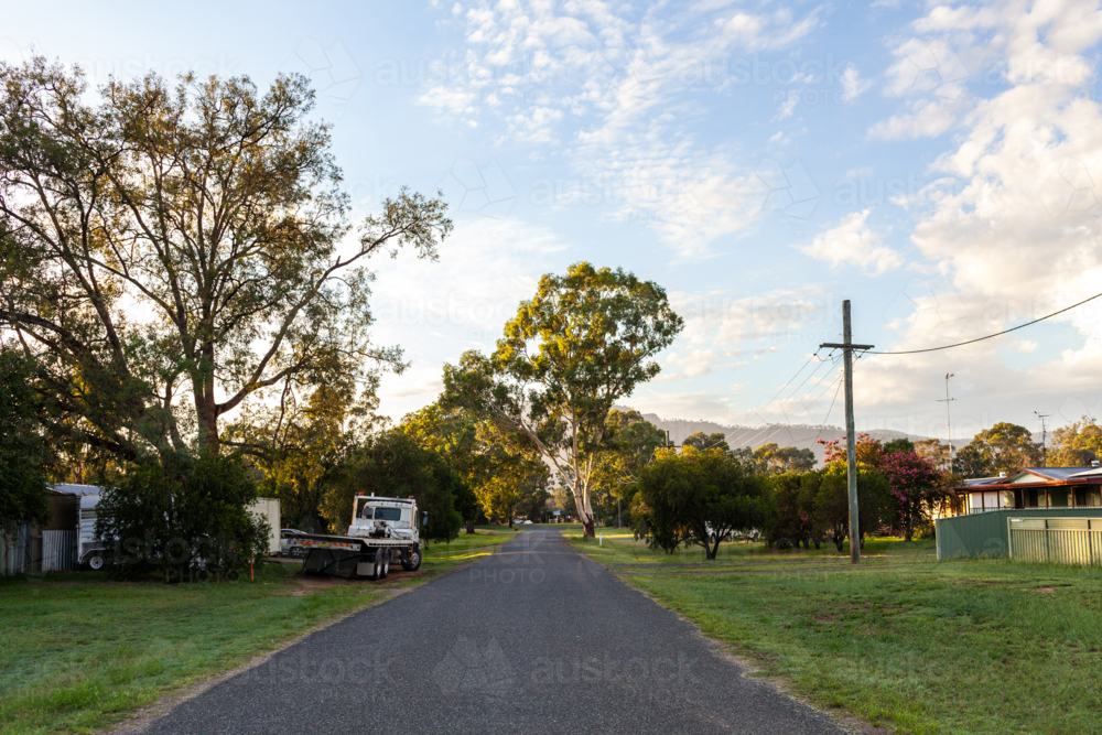 Quiet unmarked country street in little village of Broke early one summer morning - Australian Stock Image