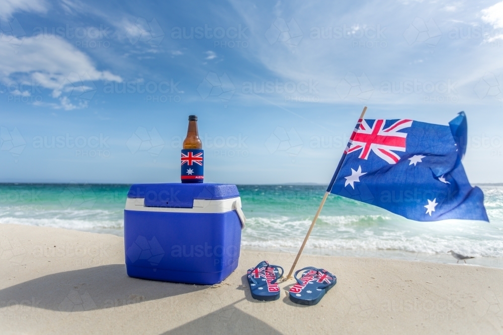 Quintessential Australian summer.  Esky, beer bottle in a cooler, thongs and Australian flag - Australian Stock Image