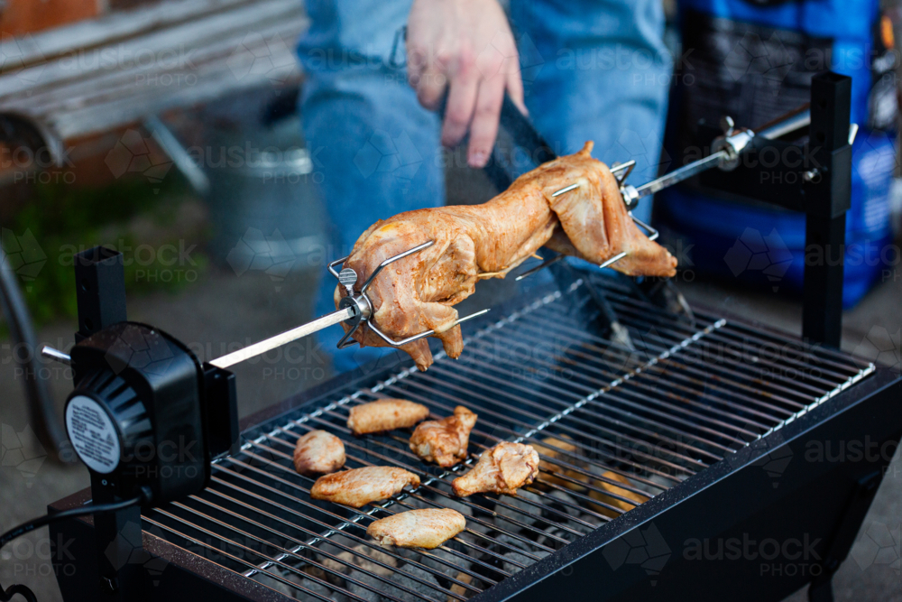 Image of Rabbit cooking over charcoal fire pit grill in backyard with ...