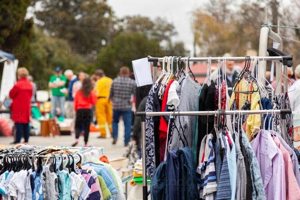 Racks of clothes at car boot sale market - Australian Stock Image