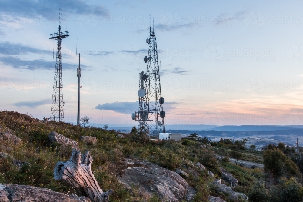 Radio towers in grassy landscape in the evening - Australian Stock Image