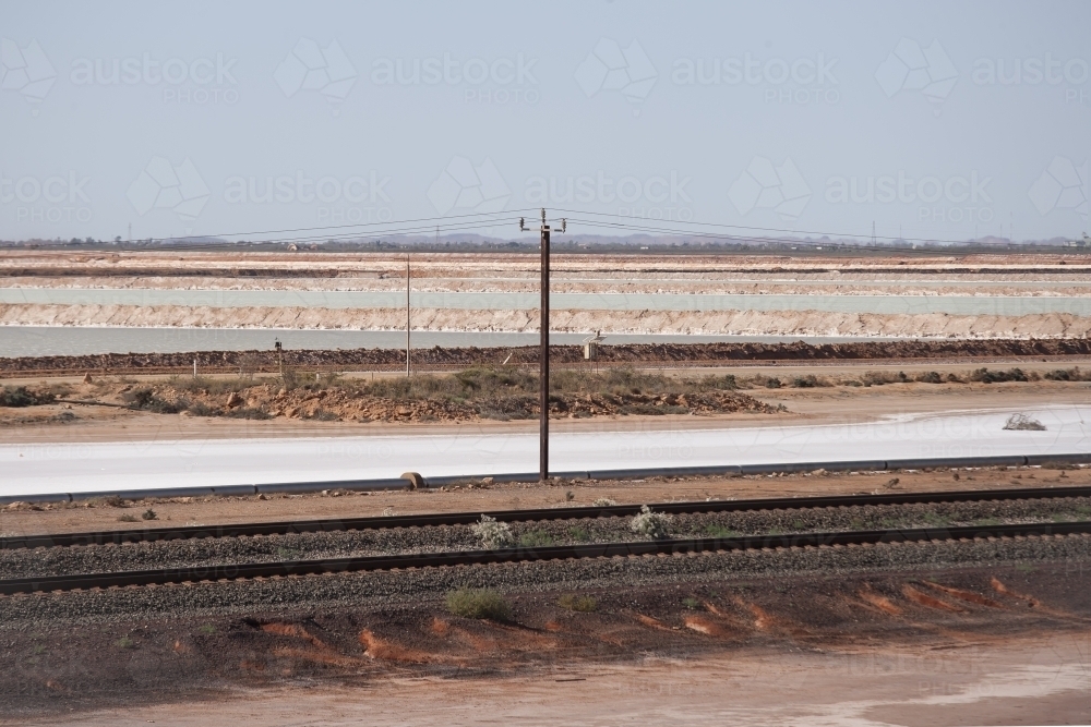 Rail line with salt lake in background - Australian Stock Image