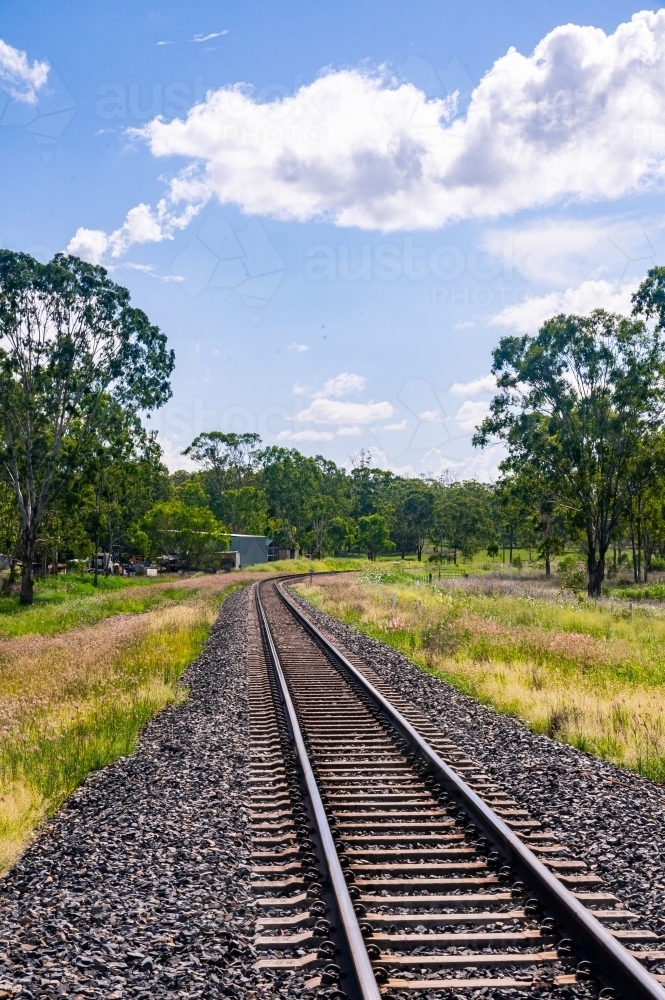 Rail tracks in Queensland countryside during summer - Australian Stock Image