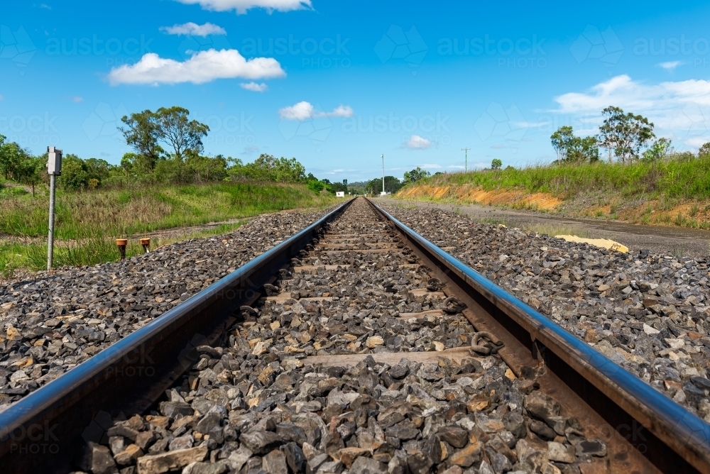 Rail tracks in Queensland countryside during summer - Australian Stock Image