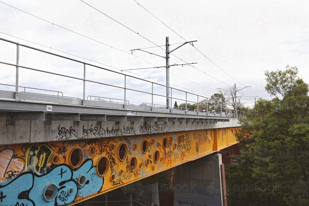 Railway bridge in Clifton Hill with graffiti covering side - Australian Stock Image