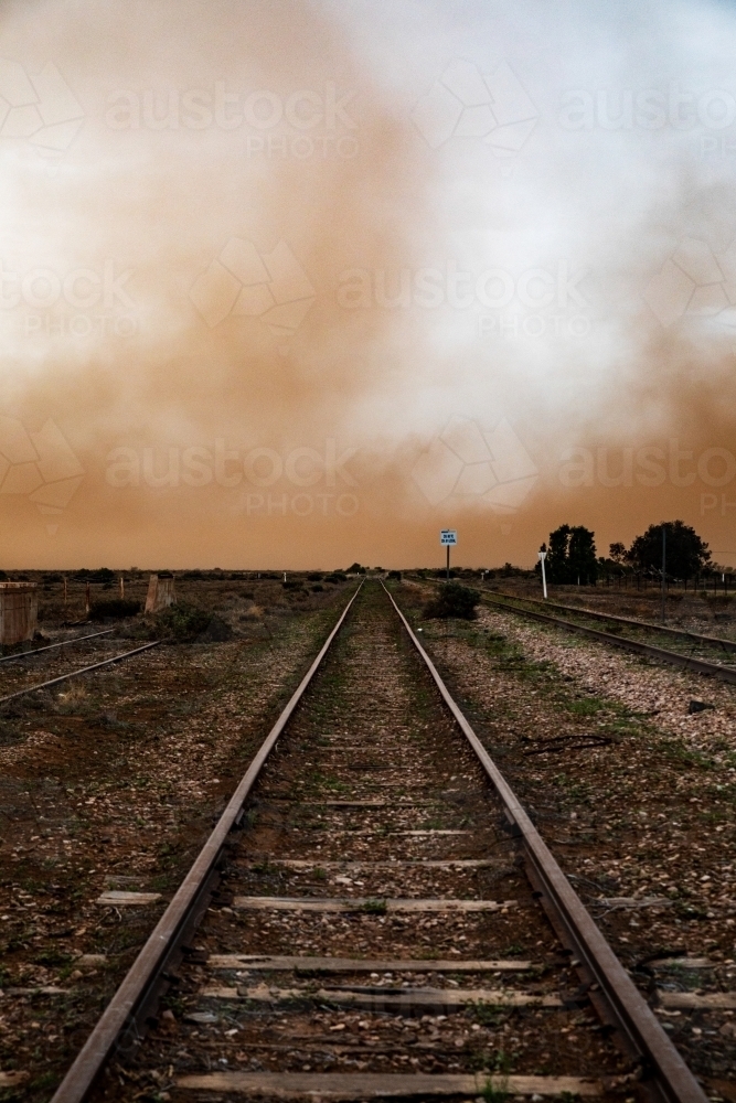 Railway tracks leading into dust storm - Australian Stock Image