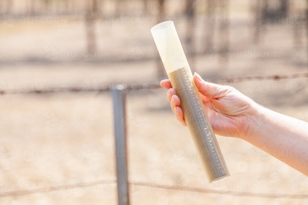 Rain gauge full of dust drought concept only dust - Australian Stock Image
