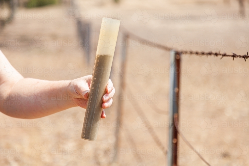 Rain gauge full of dust drought concept only dust - Australian Stock Image