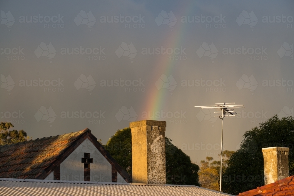 Rainbow coming out from a chimney after a storm - Australian Stock Image