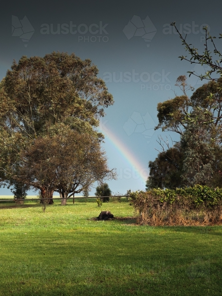 Rainbow in the backyard of a rural farm homestead - Australian Stock Image
