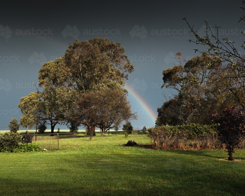 Rainbow in the backyard of a rural farm homestead - Australian Stock Image