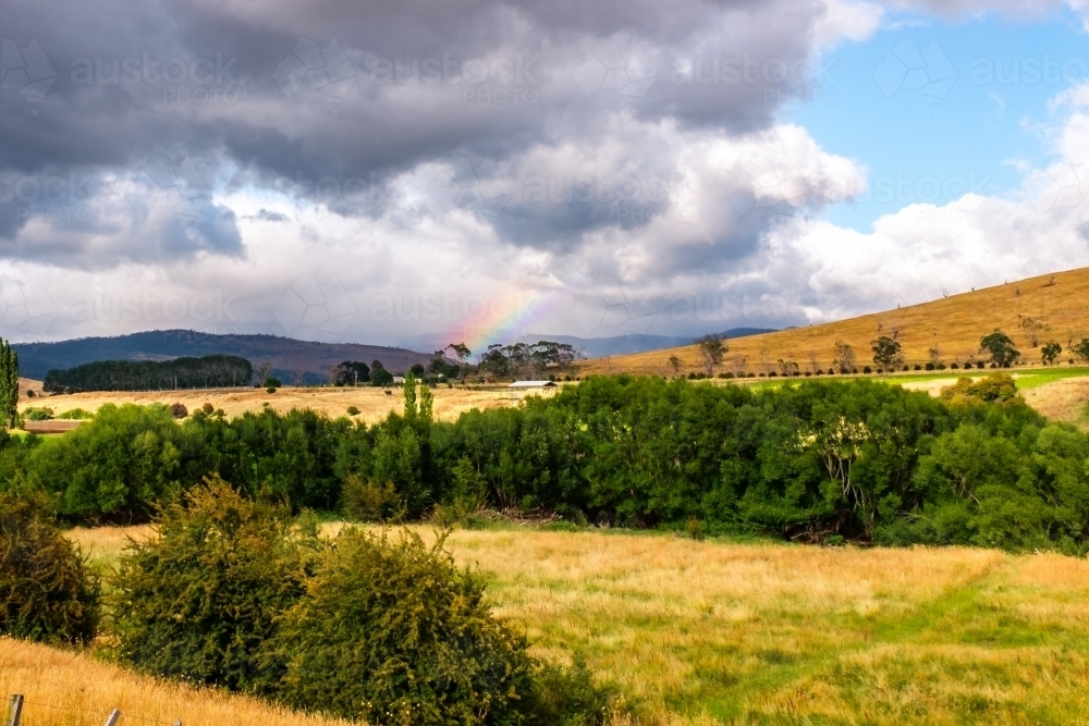 rainbow in the middle of a field - Australian Stock Image