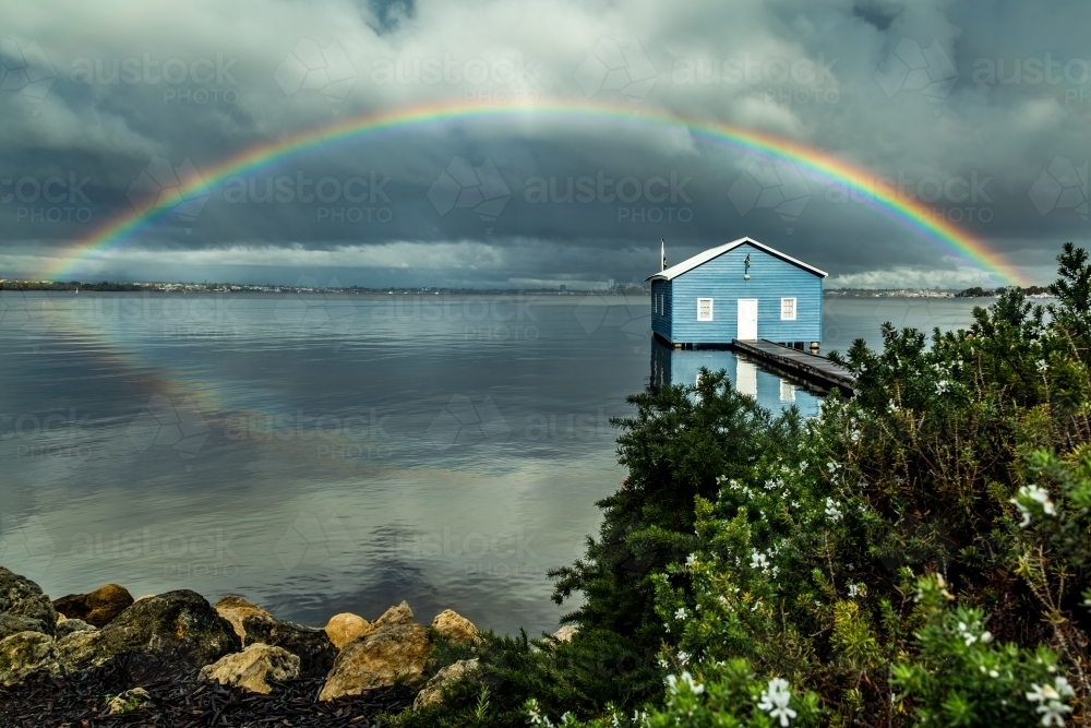 Rainbow over Crawley Edge blue boatshed, Perth, Western Australia, Australia - Australian Stock Image