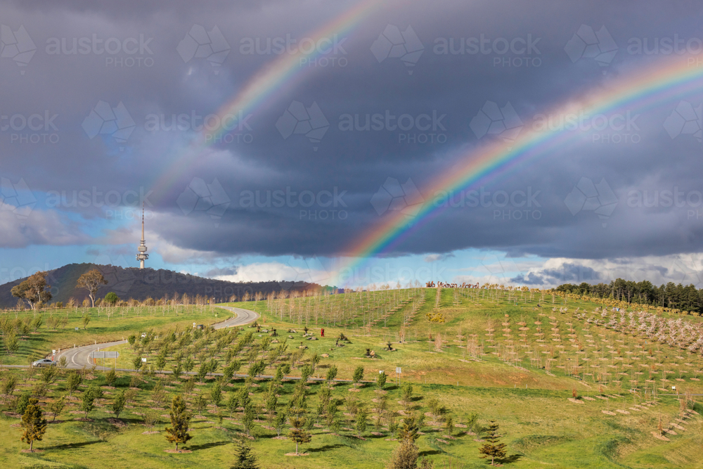 Rainbows over hills in Canberra - Australian Stock Image