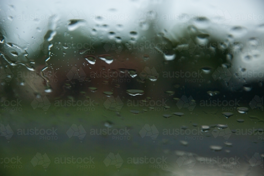 raindrops on a window with a blurry background - Australian Stock Image