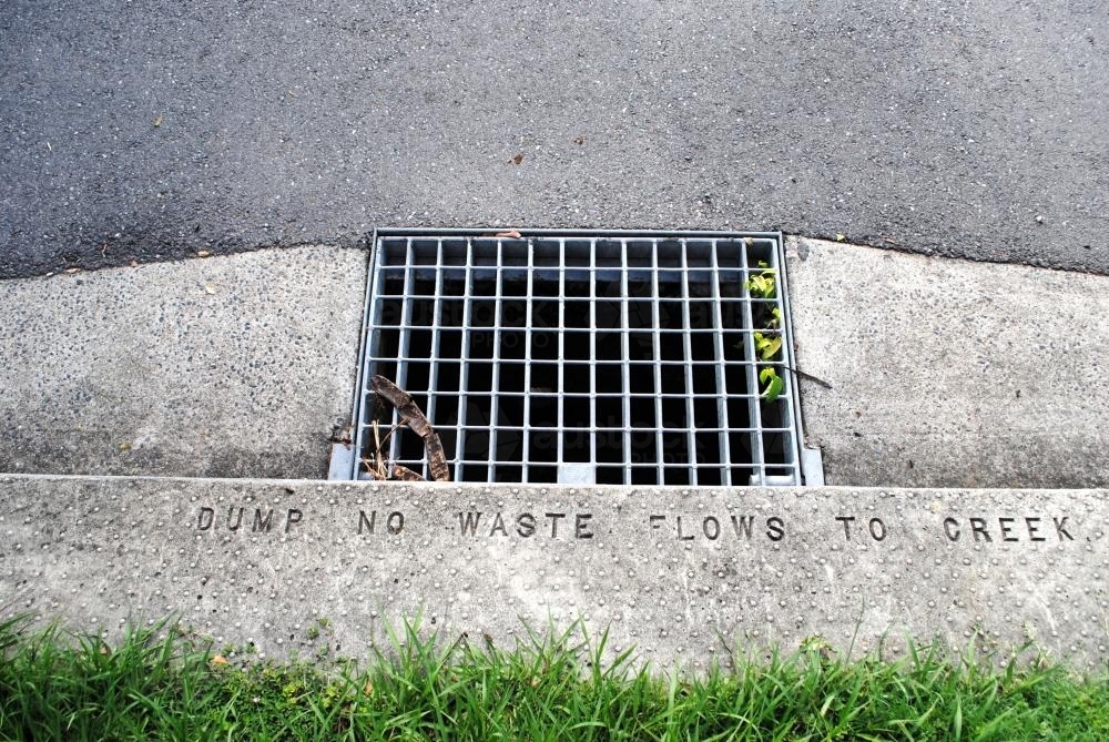 Rainwater drain on the kerb of a street in a Brisbane suburb - Australian Stock Image