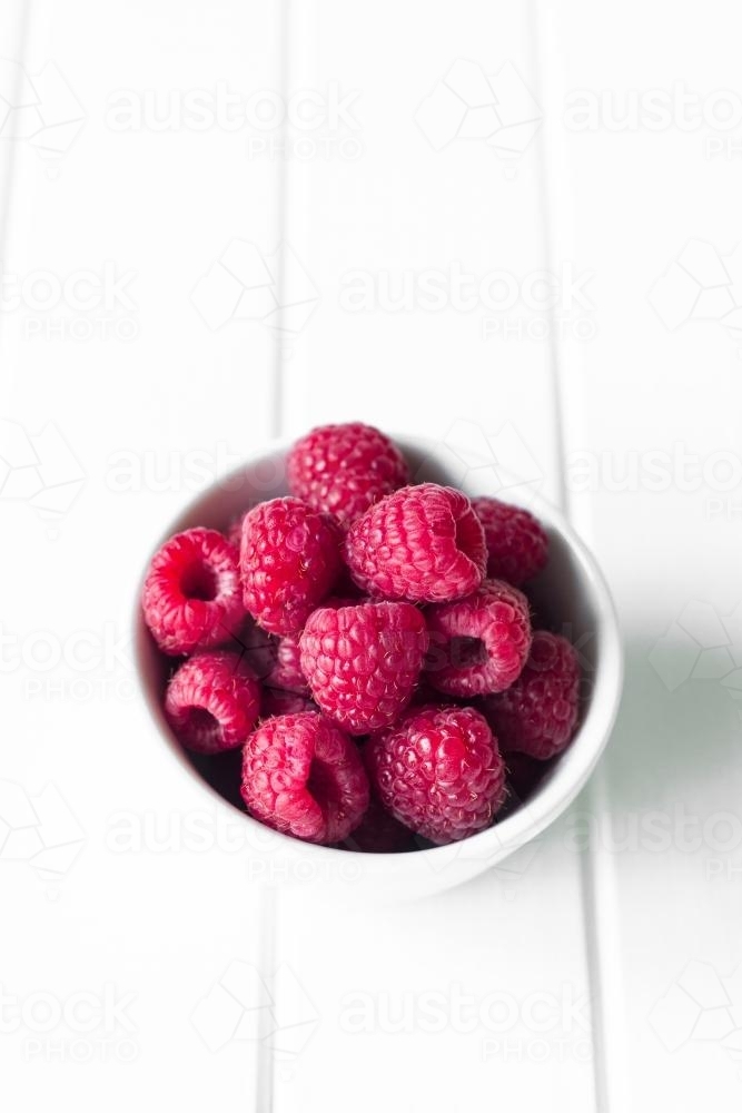 raspberries in a white bowl - Australian Stock Image