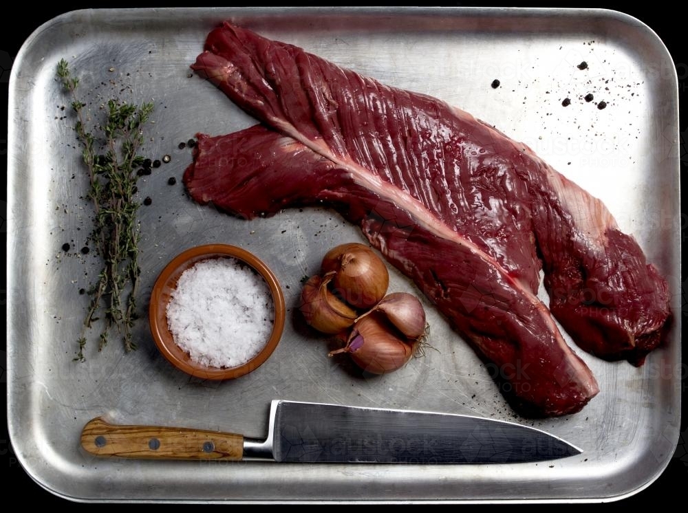 Raw Beef Hanger Steak with shallots on tray - Australian Stock Image
