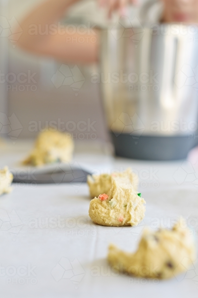 raw dough on trays with little chef in background - Australian Stock Image