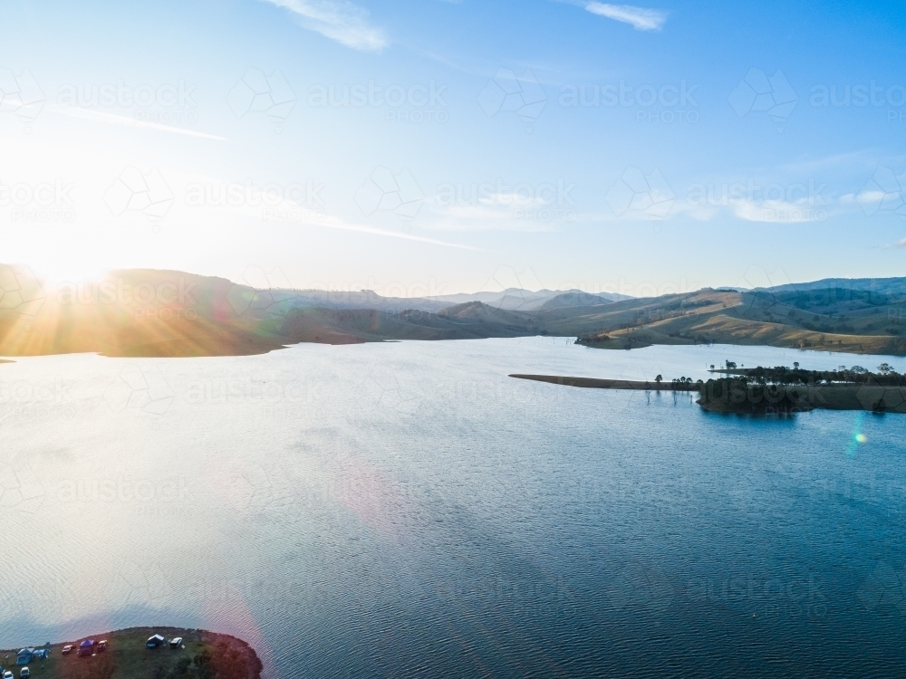 Rays of sunset light over water storage dam in Hunter Valley, Australia - Australian Stock Image