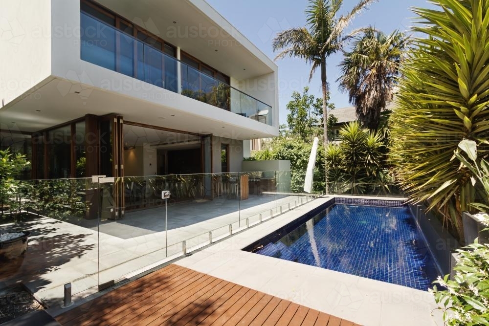 Rear landscaped yard with pool of architect designed home - Australian Stock Image