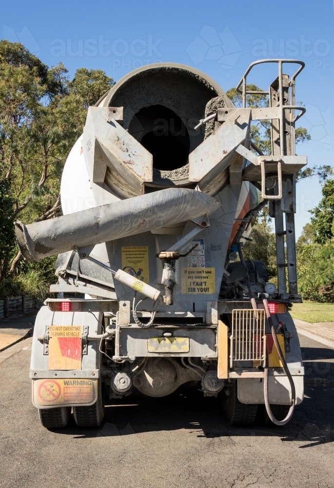 Rear view of concrete truck delivering concrete to building site - Australian Stock Image