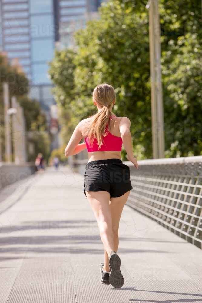 Rear View of Jogger Exercising in the City - Australian Stock Image