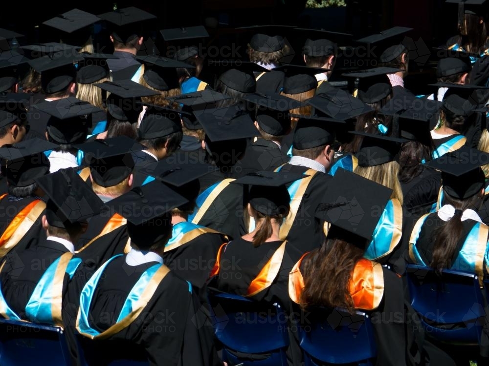 Rear view of student in gowns and mortar boards - Australian Stock Image