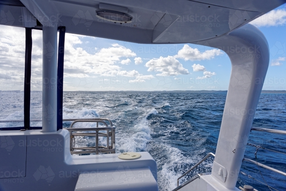 Rear view of waves created by moving boat on the ocean - Australian Stock Image