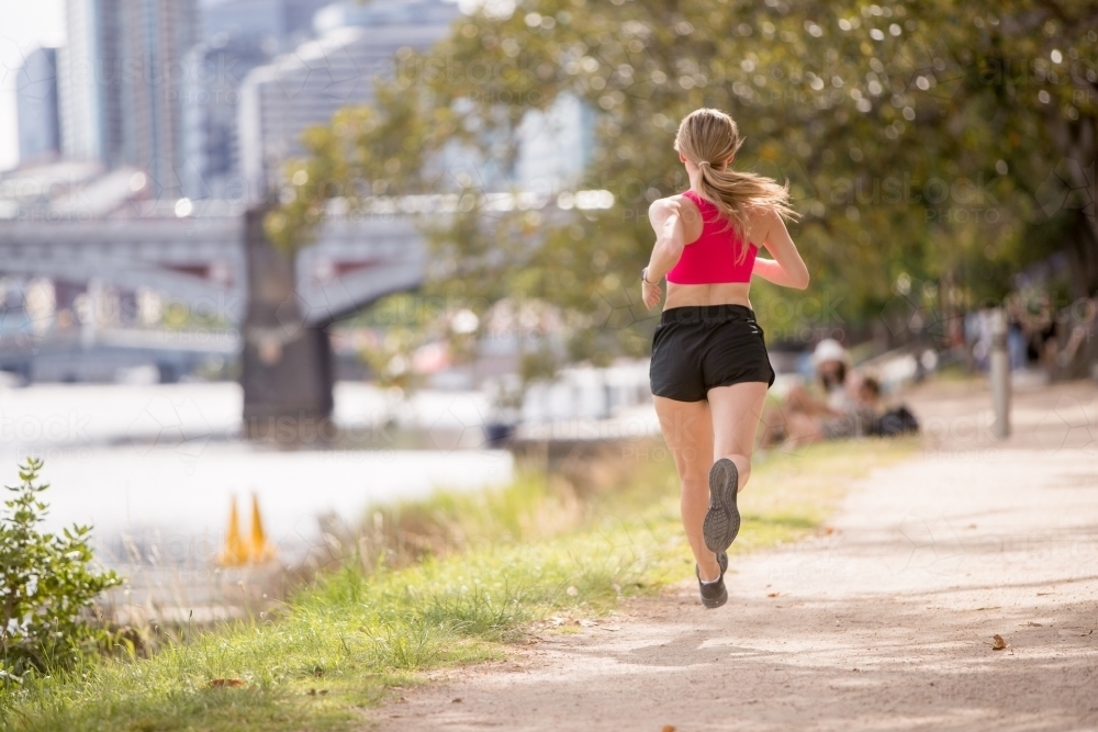 Rear View of Woman Jogging by the Yarra - Australian Stock Image