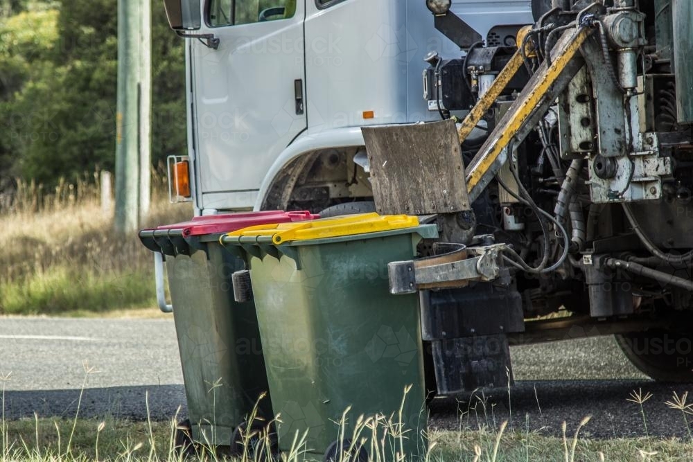 Image of Recycling bin being collected and emptied by truck Austockphoto