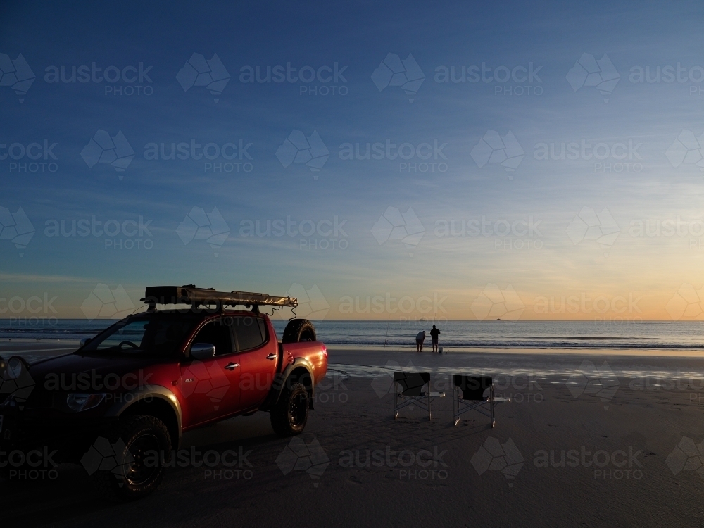 Red 4WD on Cable Beach at Sunset - Australian Stock Image