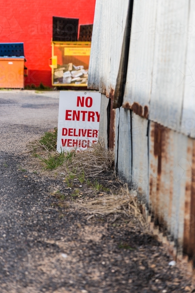 Red and white no entry sign next to rusty iron shed - Australian Stock Image