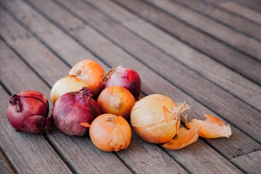 Red and white onions on wooden table background - Australian Stock Image