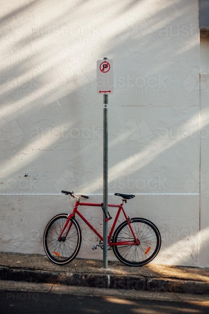 Red bike on urban street - Australian Stock Image