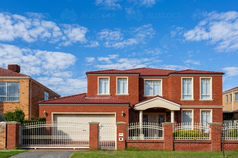 red brick house front of two storey home in Victoria - Australian Stock Image