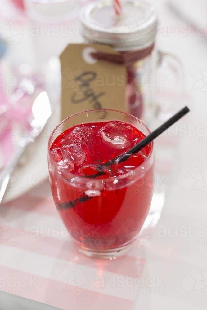Red cordial at children's birthday party - Australian Stock Image