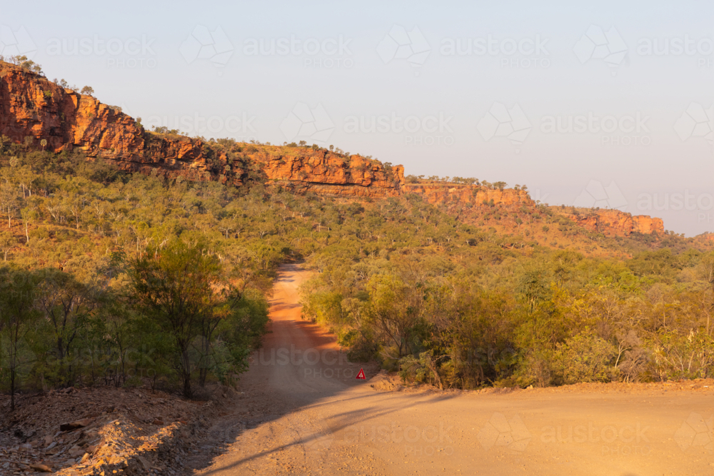 Red dirt outback gravel track in Northern Territory - Australian Stock Image