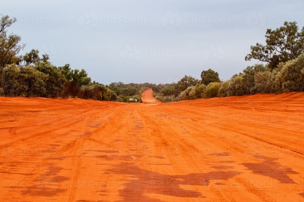 Red dirt road disappearing into the distance - Australian Stock Image