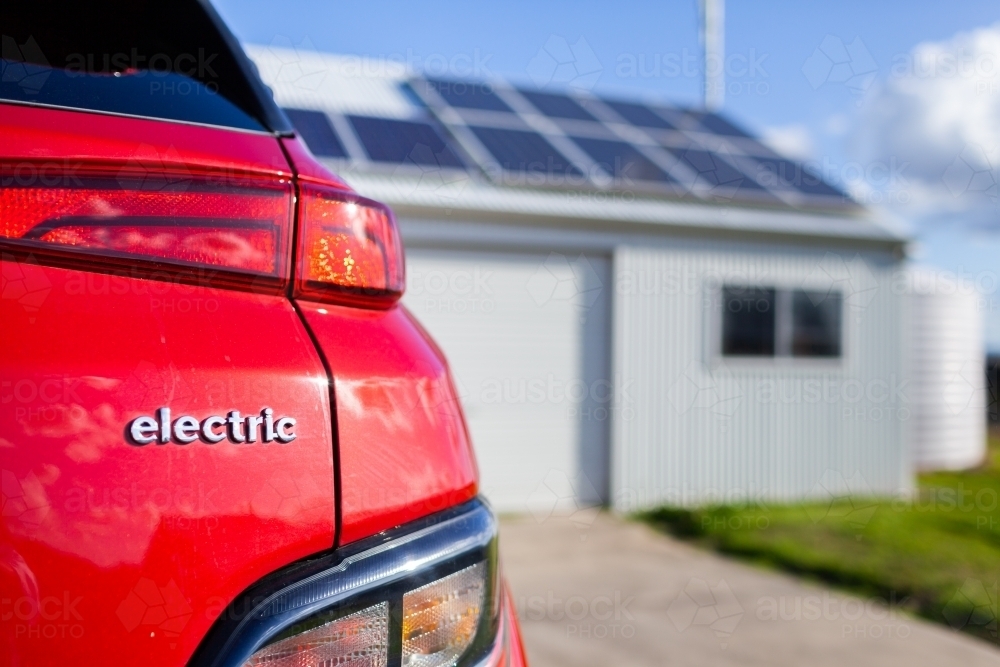 Image of Red electric vehicle with copy space and out of focus solar ...