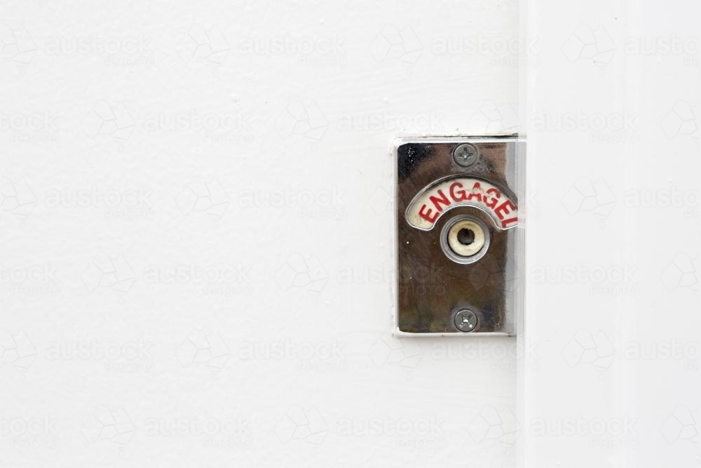 Red engaged sign turned on in public toilet - Australian Stock Image
