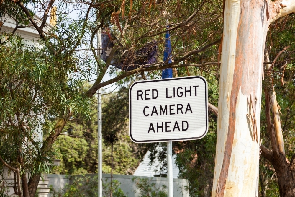 Red light camera ahead sign in city - Australian Stock Image