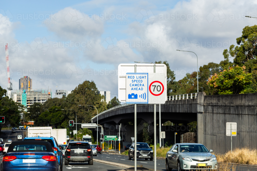 Red light speed camera ahead sign at intersection in Sydney - Australian Stock Image
