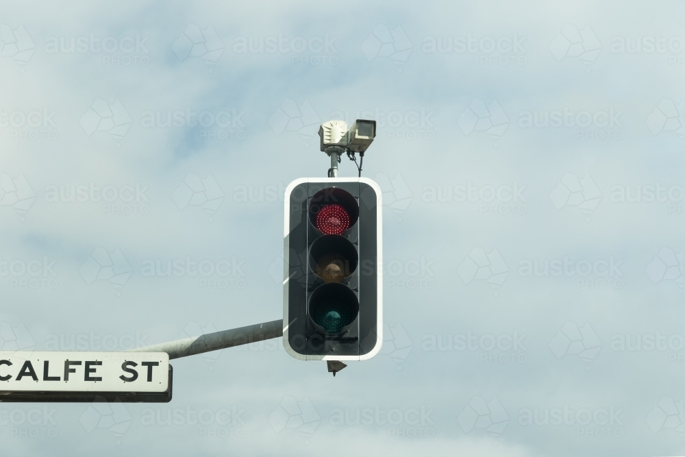 Red light speed camera mounted on traffic lights and  street sign - Australian Stock Image