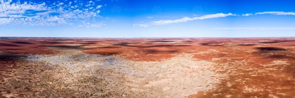 Red outback land against blue sky - Australian Stock Image