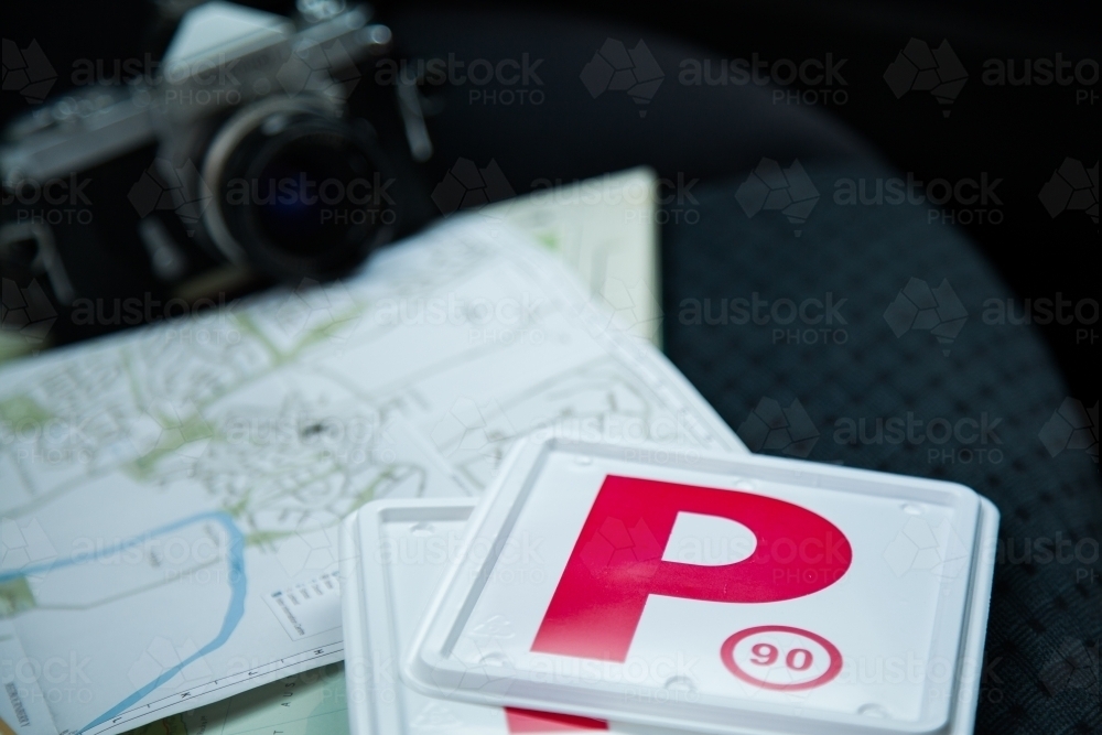 Red P plates and map on back seat of car - Australian Stock Image