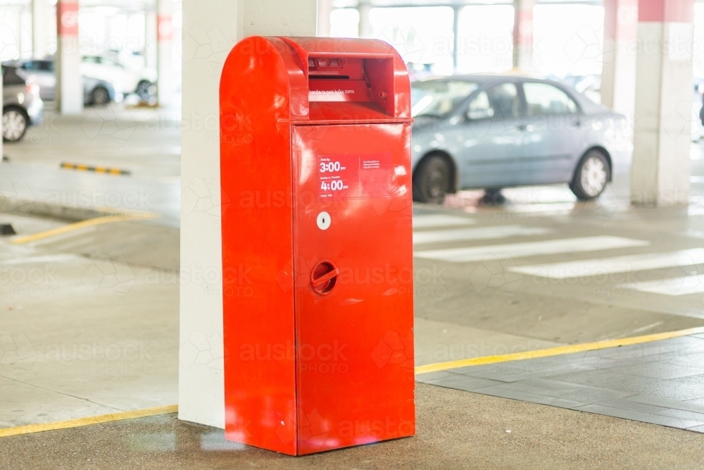 Red post box near shopping center - Australian Stock Image