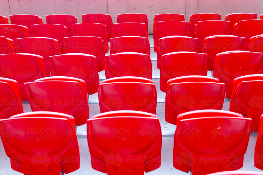 Red seats (empty) at an outdoor arena - Australian Stock Image